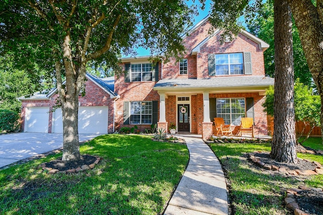 view of front of home featuring a garage, a front yard, and a porch