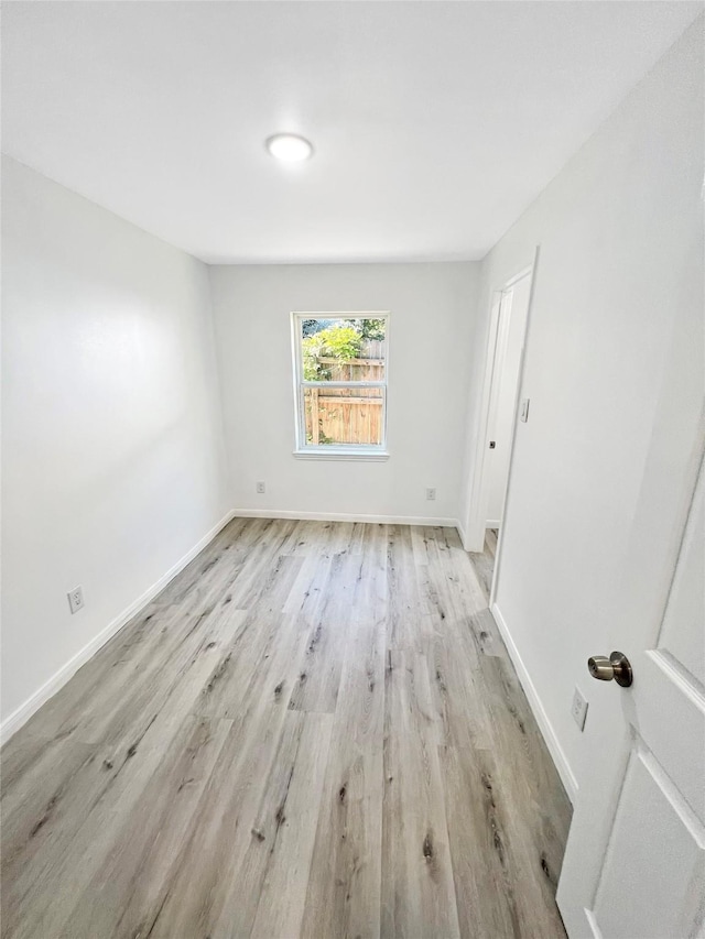 spare room featuring light hardwood / wood-style floors