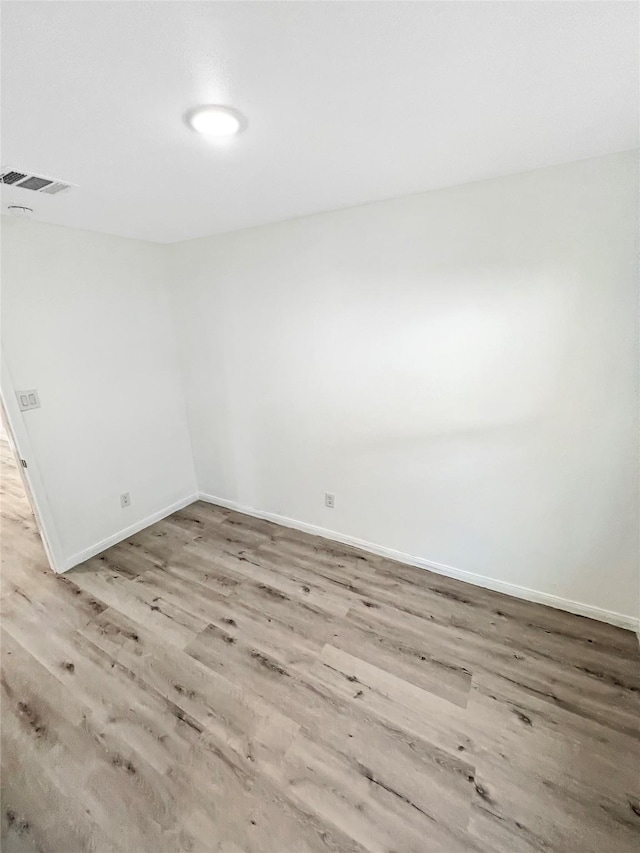 unfurnished room with light wood-type flooring