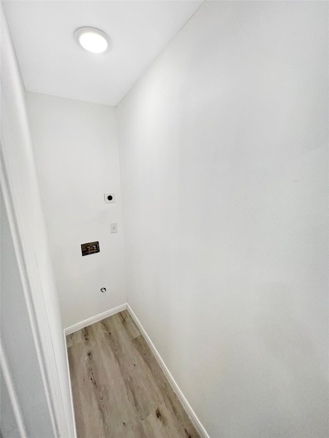 washroom featuring electric dryer hookup and light hardwood / wood-style floors