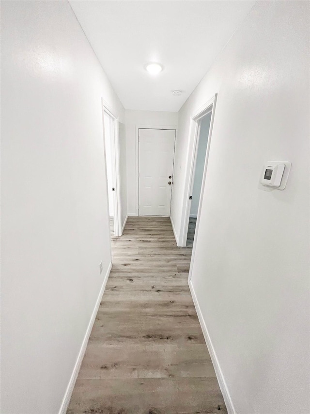 corridor with light hardwood / wood-style flooring