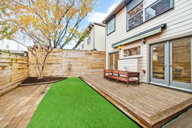 view of yard with a deck and french doors