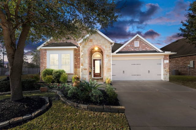 view of front of property with cooling unit and a garage