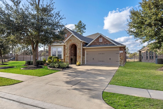 view of front of home featuring a garage and a front lawn