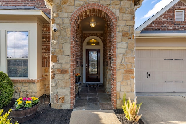 12622 Baldwin Springs Ct, Tomball, TX 77377 - view of exterior entry featuring brick siding, stone siding, and an attached garage