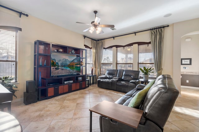 12622 Baldwin Springs Ct, Tomball, TX 77377 - living room with a ceiling fan, arched walkways, plenty of natural light, and light tile patterned flooring