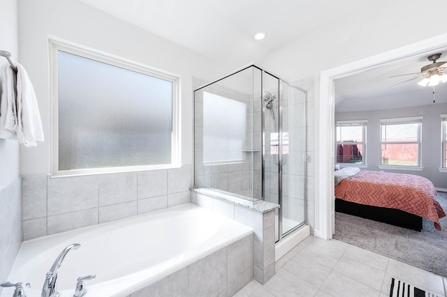 bathroom featuring tile patterned flooring, shower with separate bathtub, and ceiling fan