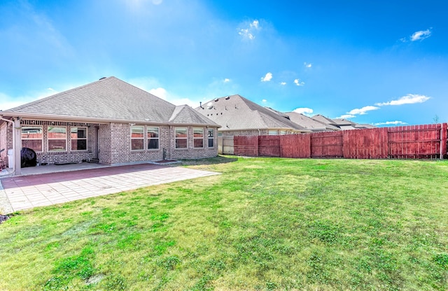 back of house featuring a patio and a lawn