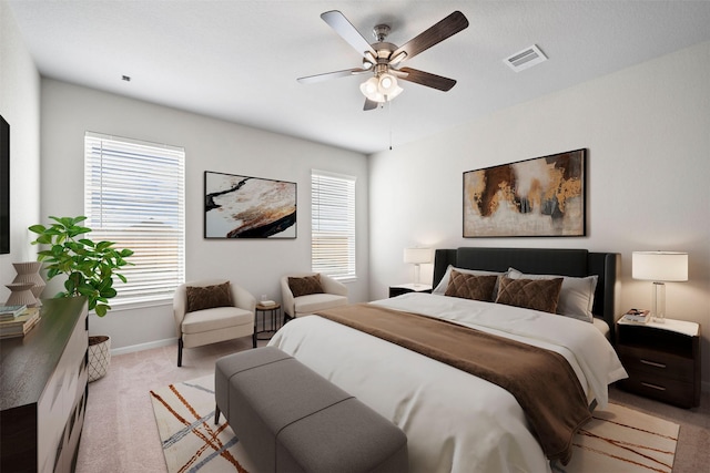 bedroom with ceiling fan, light colored carpet, and multiple windows