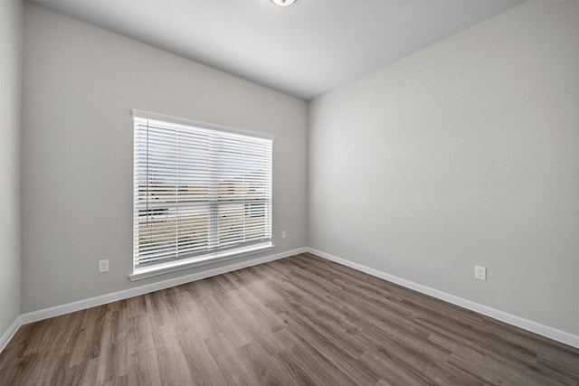 unfurnished room with wood-type flooring