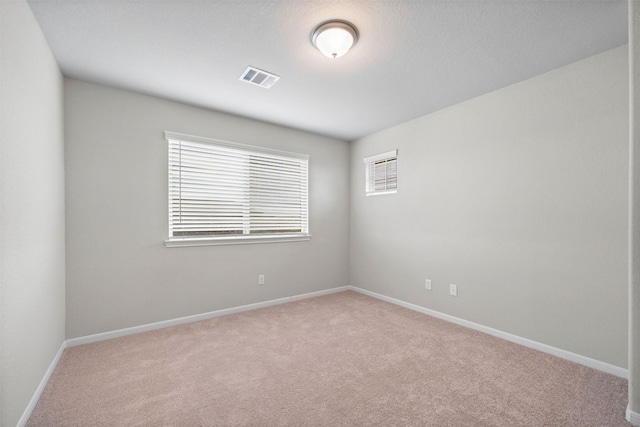 spare room with light carpet