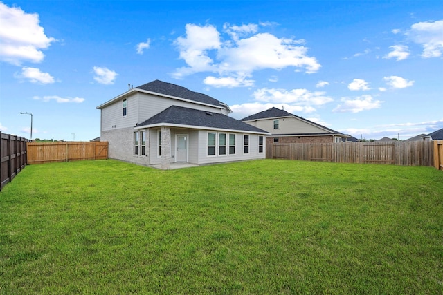 back of house with a yard