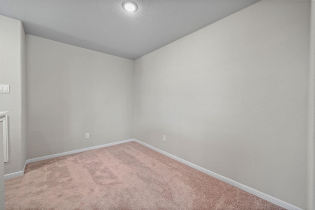 carpeted spare room with a textured ceiling