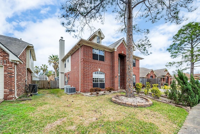 exterior space with a yard and central AC unit