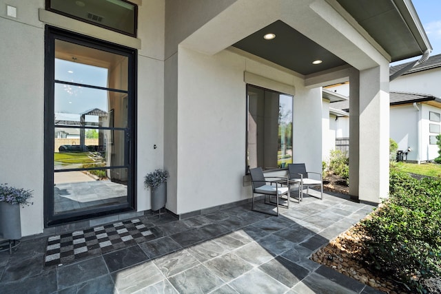 property entrance featuring a patio area