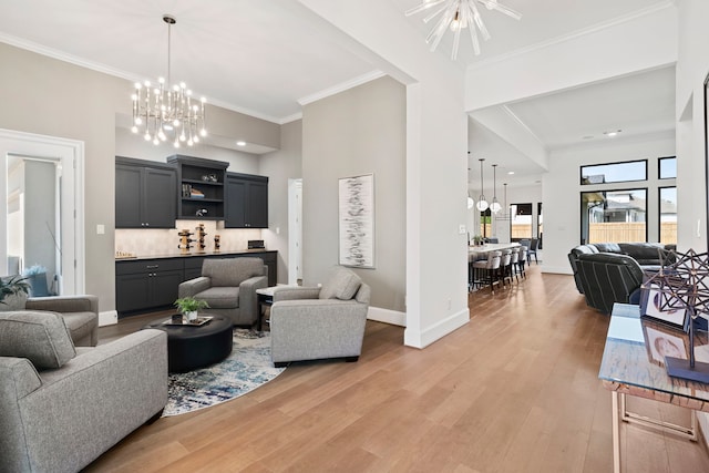 living room with hardwood / wood-style flooring, crown molding, and a chandelier