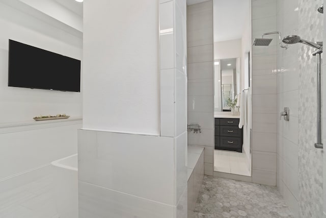 bathroom with shower with separate bathtub, tile walls, and vanity