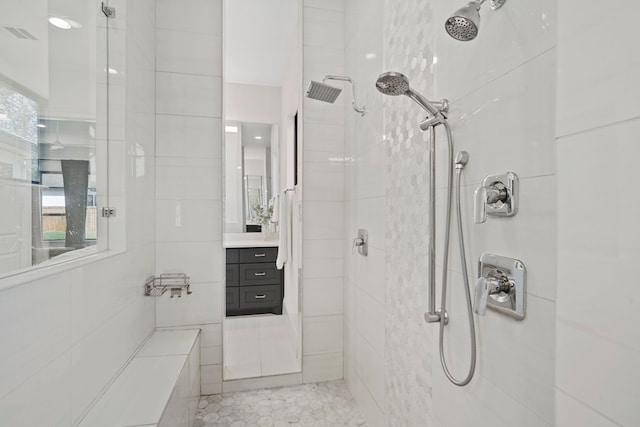 bathroom with vanity and tiled shower