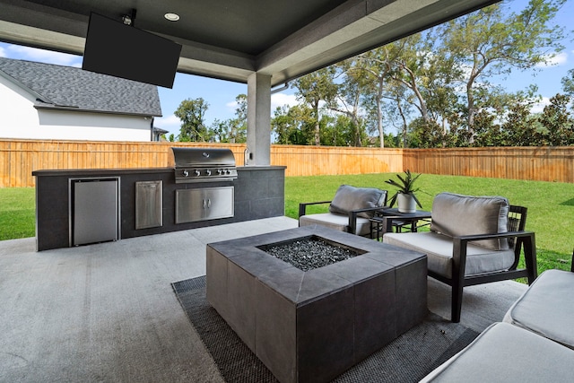 view of patio with a fire pit, grilling area, and an outdoor kitchen