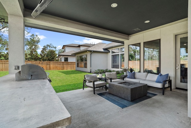 view of patio / terrace with an outdoor living space with a fire pit