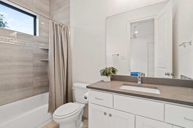 full bathroom featuring vanity, shower / tub combo, and toilet