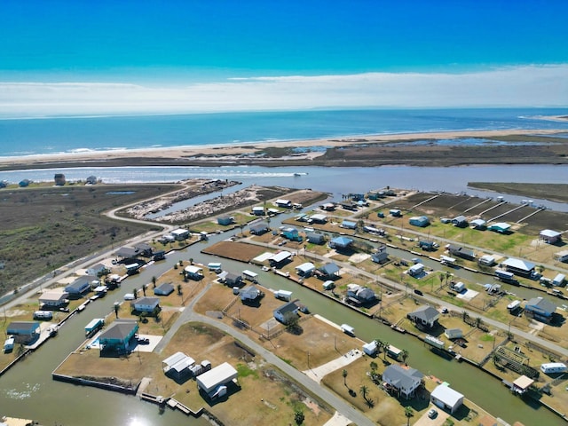 drone / aerial view with a water view and a view of the beach