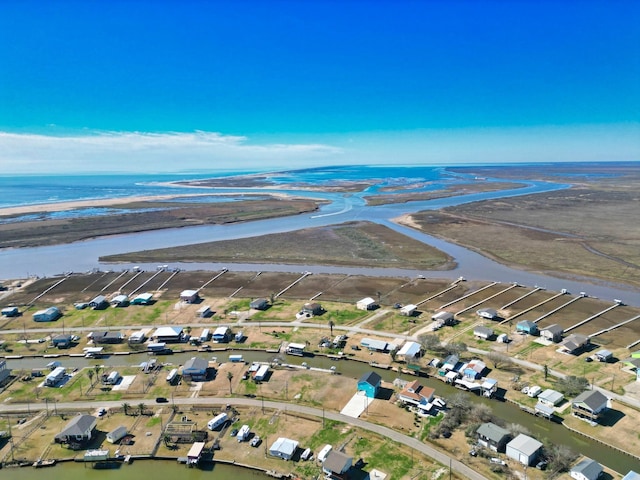 aerial view with a water view and a beach view