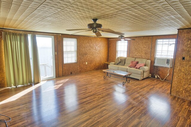 unfurnished living room featuring cooling unit, wood-type flooring, and ceiling fan