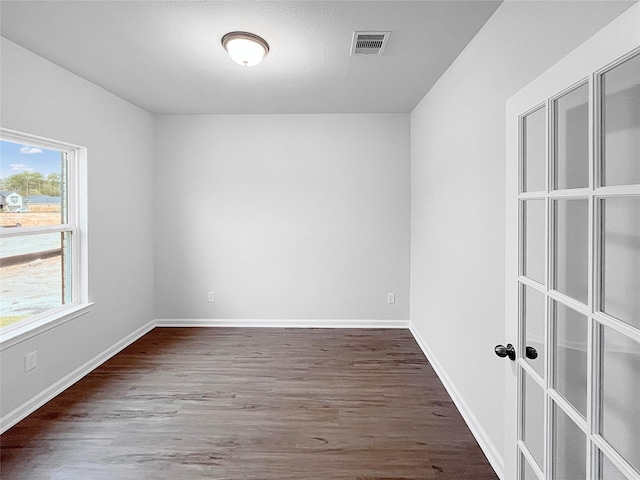 spare room with wood-type flooring