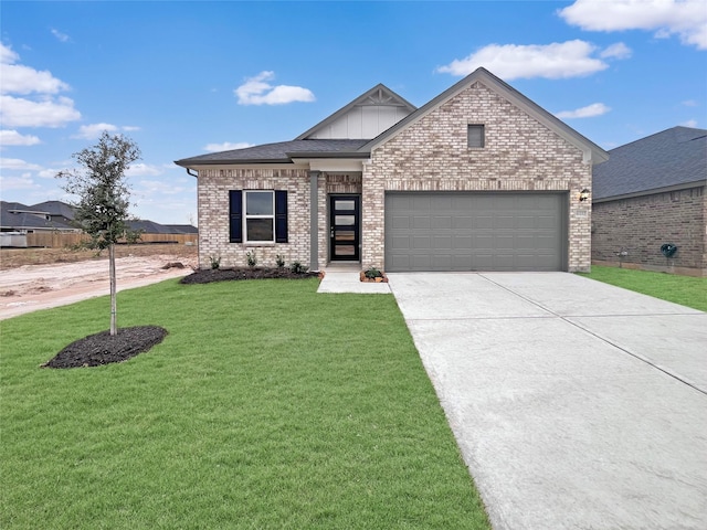 view of front of house with a garage and a front lawn