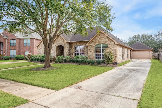 view of front of house featuring a garage and a front lawn