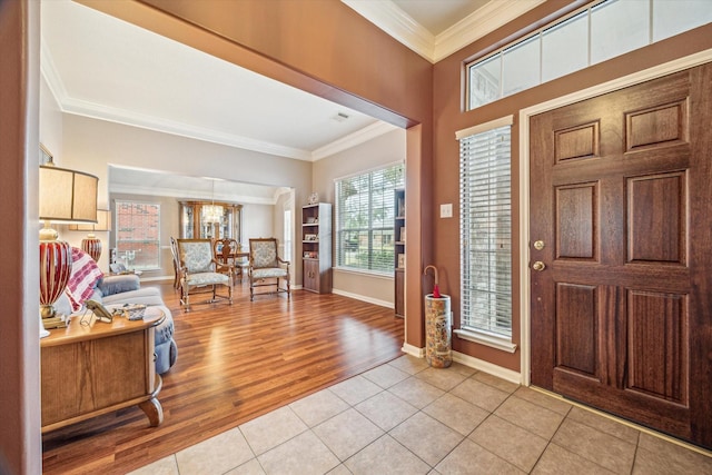 foyer featuring crown molding and light tile patterned floors