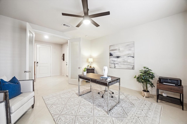 office featuring ceiling fan, light tile patterned flooring, visible vents, and baseboards