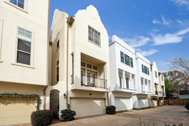 view of building exterior featuring concrete driveway and an attached garage