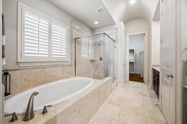 full bathroom featuring a shower stall, visible vents, a bath, and vanity