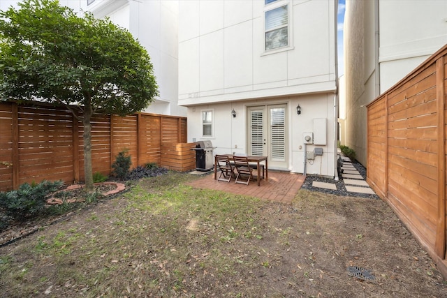 rear view of house featuring a patio area and a fenced backyard