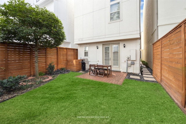 back of property featuring a patio, a lawn, and a fenced backyard