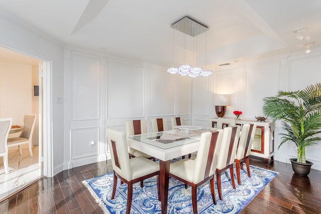 dining room with an inviting chandelier and dark hardwood / wood-style floors