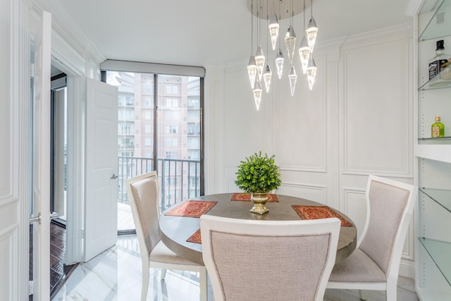 dining room featuring floor to ceiling windows and a chandelier