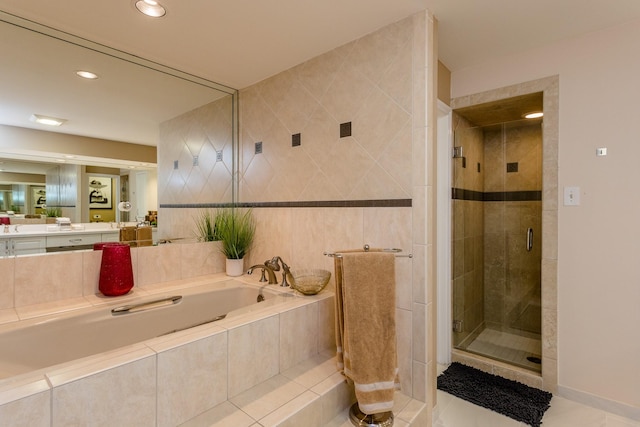 bathroom with plus walk in shower, tile walls, vanity, and tile patterned floors