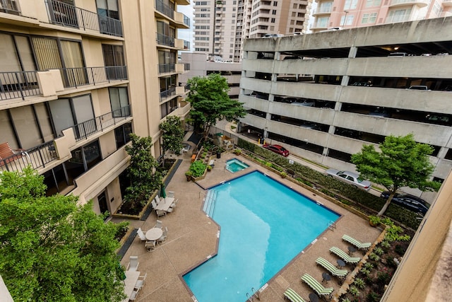 view of pool with a hot tub and a patio area