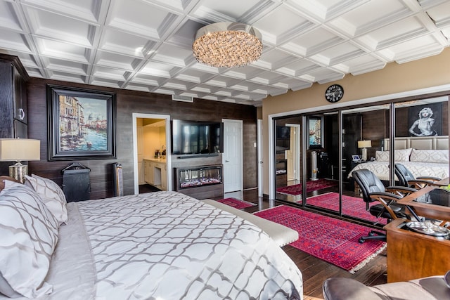 bedroom with hardwood / wood-style flooring and coffered ceiling