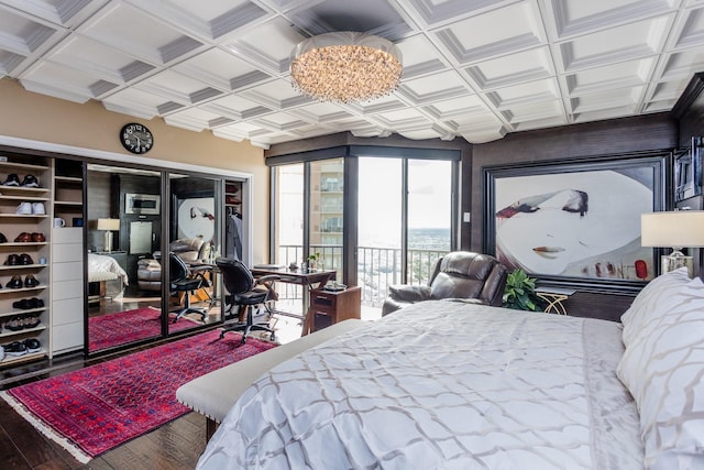 bedroom with hardwood / wood-style floors, coffered ceiling, access to outside, and a notable chandelier