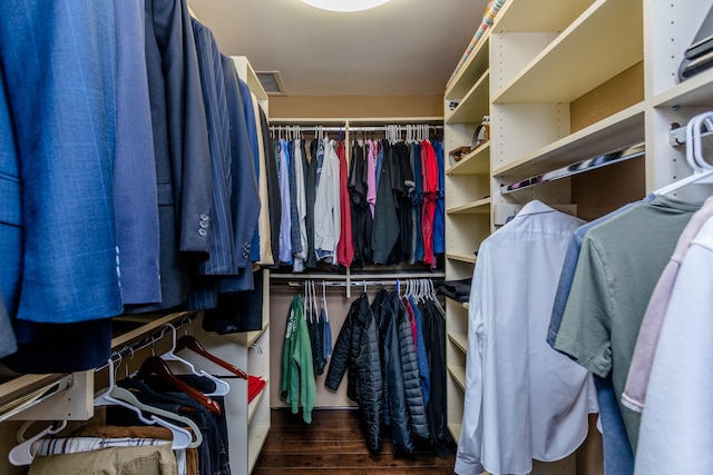 spacious closet featuring dark hardwood / wood-style floors