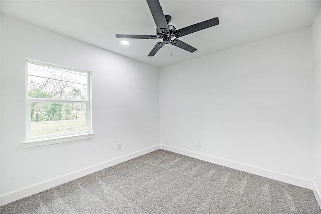 unfurnished room featuring ceiling fan and carpet