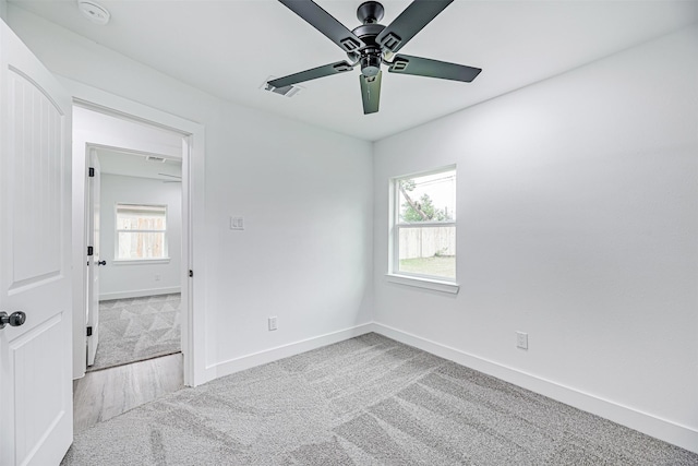 carpeted spare room with ceiling fan