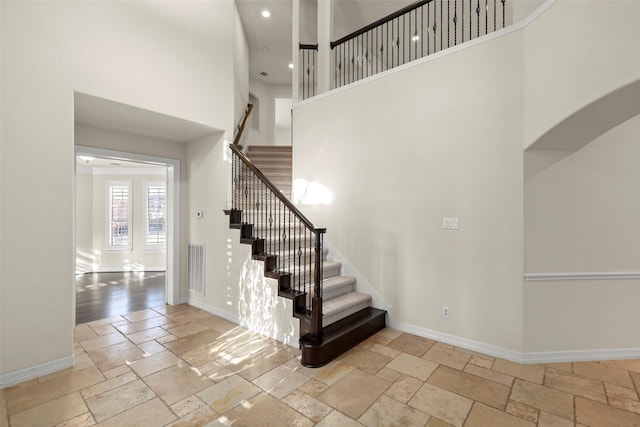 staircase featuring a high ceiling