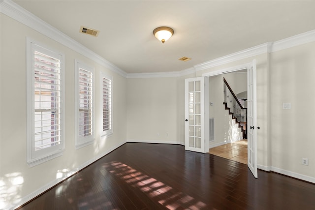 unfurnished room featuring dark wood-type flooring, crown molding, and french doors