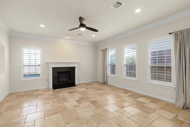 unfurnished living room with a tiled fireplace, crown molding, and ceiling fan