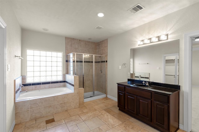 bathroom with vanity and independent shower and bath